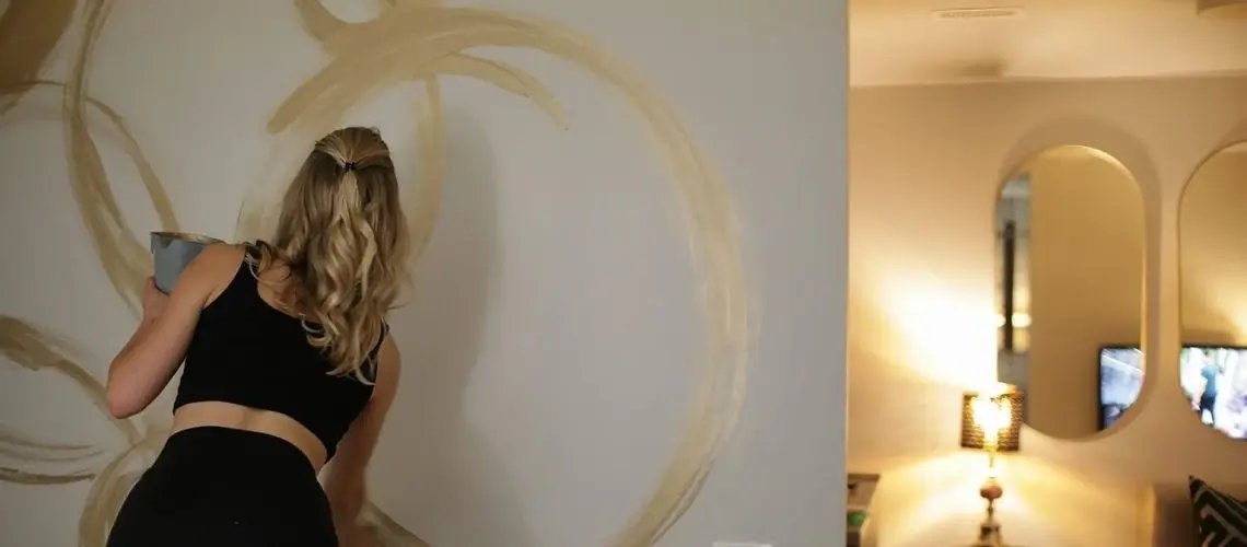 Designer Brooke Young painting in apartment 2C